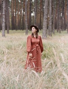 LIANA prairie dress has puff sleeves and fitted bodice fastened with front line coconut buttons. The skirt falls in a flattering A-line shape with two side seam pockets. The balloon sleeves comdined with a maxi length gives our linen dress a Victorian charm, striking the right balance between vintage and modern fit. DETAILS: * medium weight linen fabric; * colour - Rust; * puff sleeves finished with battons; * A-line skirt; * additional belt; * side seam pockets; * maxi length 130 cm/51" (another length is possible) ; MATERIAL: * 100% linen (flax); * OEKO-TEX Standard 100 certified linen; * pre-washed before sewing; SIZING: XXS US (00-0) / EU XS (34) * BODY MEASUREMENTS: Bust ± 31"/ ± 80 cm Waist ± 24"/ ± 60 cm Hips ±33"/ ± 84 cm XS US (0-2) / EU S (36) * BODY MEASUREMENTS: Bust ± 33"/ ± 8 Fall Linen Dress With Button Cuffs, Mori Girl Clothing, Red Linen Dress, Long Linen Dress, Dress Cottagecore, Cottagecore Dress, Linen Maxi Dress, Prairie Dress, Fall Skirts