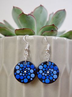 Hand painted dot mandala earrings 2cm diameter circle pendants hanging on earring hooks Painted on front side - blue, white Solid single colour on back - black (same as background on front) Pendants; wood, acrylic paint, satin varnish Fixing; silver plated Any questions please don't hesitate to drop me a message :) (all earrings are hand painted therefore are not be perfectly symmetrical) Mandala Jewelry, Mandala Earrings, Dot Mandala, Wood Acrylic, Dot Art Painting, White Solid, Black Necklace, Earring Hooks, Wood Earrings