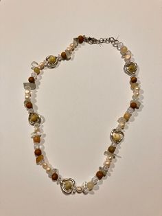 A cute earthy themed stone beaded necklace. coffee/brown, pearl, stone, and silver heart beads, and more Pearl Necklace Aesthetic, Beaded Stone Necklace, Brown Beaded Necklace, Necklace Aesthetic, Granny Square Crochet Patterns Free, Earthy Jewelry, Beaded Jewlery, Pearl Stone, Stone Beaded Necklace