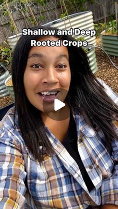 a woman with long black hair and plaid shirt smiling at the camera while sitting on a bench