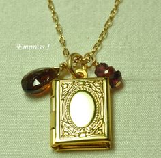 "This precious little gold plated locket opens to hold your keepsake photo.  Along side it hang a stack of faceted spinel and a faceted tundra sapphire briolette.  They suspend from an 18\" gold plated cable chain with a 14k gold filled spring ring clasp.  The locket measures 1/2\" in length. *Every handmade item from Empress I comes enclosed in a gift box with a ribbon." Gold Nickel-free Locket Necklace For Keepsake, Gold Locket Necklace Nickel-free For Keepsake, Gold Nickel-free Locket Necklace, Jewelry Book, Perfume Locket, Gold Locket Necklace, Book Locket, Locket Bracelet, Gold Locket