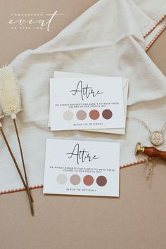 the wedding stationery is laid out on top of a white table cloth with flowers