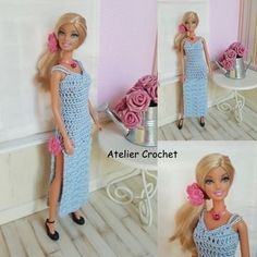 there is a doll wearing a blue dress and holding a pink rose