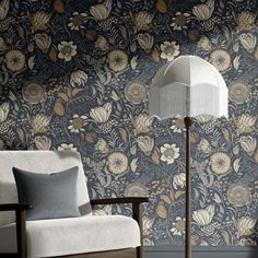 a white chair sitting next to a lamp on top of a wooden table in front of a wall