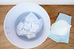 a white bowl with tissue paper on top of it