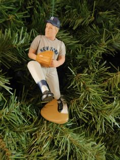 a baseball ornament hanging from a christmas tree