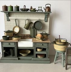 an old fashioned kitchen with pots and pans