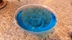 a blue glass bowl sitting on top of a counter