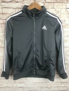 Youth Adidas Jogger Jacket.  Zip-up front jacket with pockets.  Gray with white stripes down sleeves.  Youth Medium 10-12 Gray Winter Long Sleeve Track Jacket, Fall Sportswear Track Jacket With Long Sleeves, Cold Weather Long Sleeve Sportswear Outerwear, Gray Long Sleeve Track Jacket For Fall, Gray Long Sleeve Fall Track Jacket, Adidas Fall Track Jacket With Ribbed Cuffs, Adidas Winter Track Jacket With Ribbed Cuffs, Adidas Track Jacket With Ribbed Cuffs For Fall, Adidas Sporty Crew Neck Outerwear