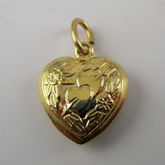 "This sterling silver, two-sided, repousse Puffy Heart Charm Number 3 features two hearts attached with cupid's arrow surrounded by flowers and foliage. Marked, Sterling. Made by Brown County Silver. Vintage and in new, never worn condition. Approximately 30 years old. Available in antiqued silver and gold vermeil. 3/4\" high with jump ring 1/2\" wide 1.1 grams approx. *Chain sold separately See more @ https://www.etsy.com/shop/brocosi" Valentine's Day Heart Charm Jewelry Collectible, Valentine's Day Collectible Jewelry With Heart Charm, Valentine's Day Collectible Heart Charm Jewelry, Collectible Heart-shaped Jewelry For Valentine's Day, Anniversary Heart Necklace With Double Heart Charms, Hallmarked Heart Necklace For Valentine's Day, Cupid Heart, Necklace Girlfriend, Brown County