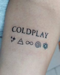 a person with a tattoo on their arm that says coldplay and other symbols in black ink