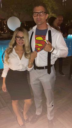 the man and woman are dressed up as superman and supergirls in front of a swimming pool