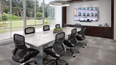 an empty conference room with chairs and a large table