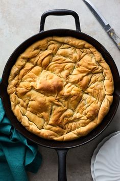 a cast iron skillet with a pie in it