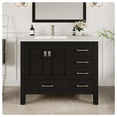 a bathroom vanity with a mirror above it and flowers in the vase on the counter