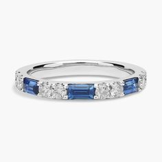 a white gold ring with blue and white stones on the sides, set in 18k white gold