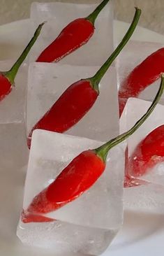 three pieces of ice with red peppers on them