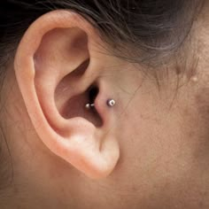 a woman's left ear with a single piercing