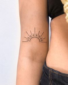 two women with tattoos on their arms and one has a sun tattoo on her arm