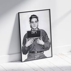 a black and white photo of a man holding a laptop