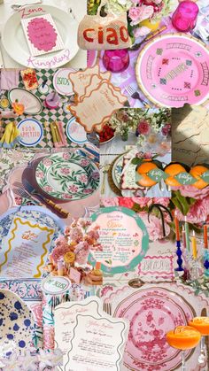 many plates and other decorative items are arranged on a tablecloth covered with pink flowers