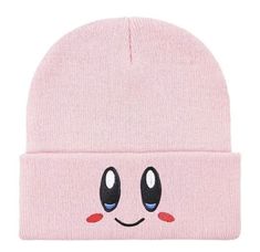 a pink beanie with an emoticive face on the front and one eye open