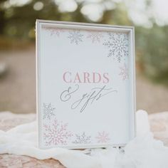 a card and gift sign sitting on top of a table