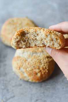 a person holding a biscuit in their right hand and the other one is half eaten