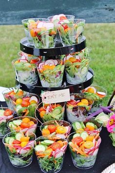 there are many salads in cups on the table