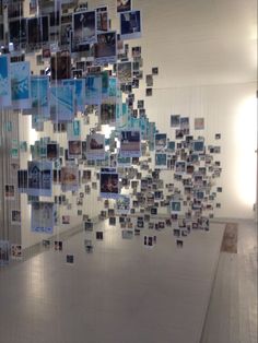 a room filled with lots of pictures hanging from the ceiling