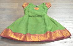 Your little one is sure to steal the show with this Green Sugandi Cotton Silk with zari lines all over the lehenga zari Maroon Red pattu border. It comes with a back rope tie to adjust the waist The yoke part is green in color with zari lines all over and pattu Maroon Red zari border sleeves to enhance the look of the gown Size  Dress Length: 29 inches (Shoulder to ankle/toes) Yoke Length: 9.5 inches (shoulder to above waist) Sleeves Length: 2.5 inches  Bust Size: 26 inches (round length - front Lehenga Pink, Pattu Langa, Gown Designer, Long Frock, Rope Tie, Green Gown, Long Frocks, Indian Dress, Indian Bollywood