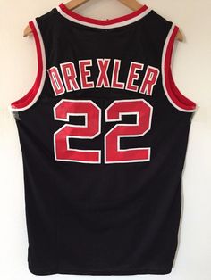 a jersey hanging on a hanger with the number 22 printed in red and black