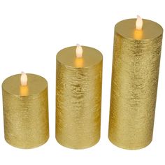 three gold colored candles are sitting next to each other