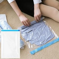 a woman sitting on the floor next to some plastic bags