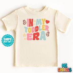 In My Todder Era Shirt, Shirt for Toddler, Funny Kids Tshirt, Retro Toddler Shirt, Trendy Natural Kids Shirt, Era Shirt for Toddler, Gift for Baby #0077 ✨ WELCOME TO OUR SHOP- M.C. Smalls ✨ Our goal is to design for you premium baby, toddler & youth clothing for all occasions. 📦PRODUCTION TIME & SHIPPING📦 Made to order- Please allow 1-3 business days for your order to be completed. Depends on the shipping method chosen and destination, but in general after the order is placed, the package will Custom Toddler Shirts, Cute Letter Print T-shirt For Playtime, Cute Multicolor T-shirt With Name Print, Cotton T-shirt With Name Print For Daycare, White Tops With Funny Print For Playtime, Multicolor Cotton Tops For Birthday, White T-shirt With Letter Print For Daycare, Pink Short Sleeve T-shirt For Daycare, Cotton Tops With Letter Print For Playtime