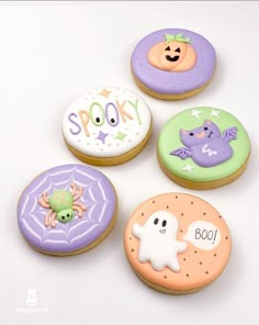 four decorated cookies with spooky and boo on them