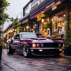 a purple muscle car parked in front of a building with lights on it's windows