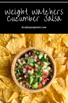 a wooden bowl filled with cucumber salsa surrounded by tortilla chips