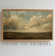 a painting hanging on the wall above it that says frame tv art work with clouds in the sky