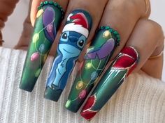 🎄🎅 Christmas Magic Press-On Nails 🎅🎄 ✨ Bring the Holiday Cheer to Your Fingertips! ✨ Get ready to deck the halls and your nails with our adorable and festive Christmas-themed press-on nail set! Featuring a cute blue cartoon character wearing a Santa hat and surrounded by sparkling Christmas lights, this set is sure to make you the star of any holiday party! 🌟 Key Features: Hand-Painted Masterpiece: Each nail is meticulously hand-painted with vibrant holiday colors and intricate designs, mak Nails Stitch, Santa Claus Nail Art, Blue Cartoon Character, Nails Festive, Festive Holiday Nails, Disney Nail Designs, Tropical Nails, Anime Nails, Christmas Cartoon