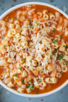 a white bowl filled with pasta and cheese