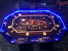 a gaming table with dice and cards on it in the shape of a wrestling ring