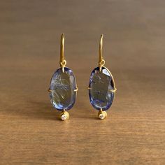 Natural-color, untreated and unheated Tanzanite drops in deep oceanic blues are accented by a foot of petite diamonds in this enduringly classic pair. 18k yellow gold Tanzanites 7/16" x 11/16" Diamonds 2mm in diameterEarrings hang 1 1/4" from the ear Each earring weighs 2.5g Tanzanite Diamond Earrings, Faberge Jewelry, Tanzanite Jewelry, Newport Rhode Island, Tanzanite Diamond, Art Nouveau Jewelry, Girly Jewelry, Unique Necklaces, Cute Jewelry