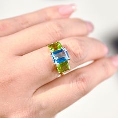 Fortune 14K Gold Diamond Topaz Peridot Swiss Blue Green Triple Gemstone Three Stone Ring  Metal: 14k Solid Yellow Gold Au585 stamped, not gold-filled or plated Gemstone: Natural Topaz (Swiss Blue), Peridot Natural Topaz: 3.40ct Natural Peridot: 2.00ct Topaz Size: 9*7mm Peridot Size: 7*5mm Natural Diamond: 0.03ct The three stones in a three stone ring tell the story of a couple's past, present, and future. The center stone, Swiss Blue Topaz, is an empathetic stone used to build the bridge between two hearts. The two olive green Peridots can open the heart chakra and bring healing energy to the wearers.  Only 5 3/4 US size is in stock. Other sizes will take 1-2 weeks to make and ship.  ▶ See the Topaz Peridot Baroque Pearl Earrings to match this Ring: https://kaifinejewelry.etsy.com/listing/ Green Multi-stone Topaz Ring For Gift, Gift Green Blue Topaz Ring, Baroque Pearl Earrings, Green Peridot, Swiss Blue Topaz, Three Stone Rings, Pearl Drop Earrings, Three Stone, Baroque Pearls