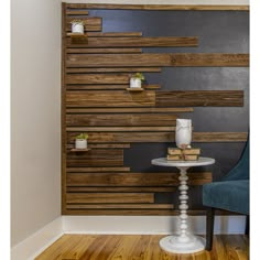 a chair and table in front of a wall with wooden planks on the walls