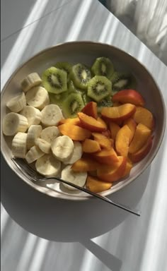 a bowl filled with sliced up fruit on top of a table