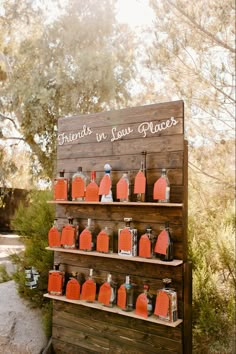 a wooden stand with orange juice bottles on it and a sign that says friends in jesus places