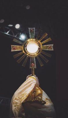 the cross has been placed on top of the cloth and is illuminated by a light bulb