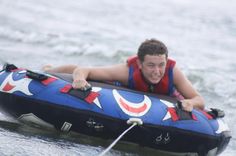 a man riding on the back of an inflatable boat