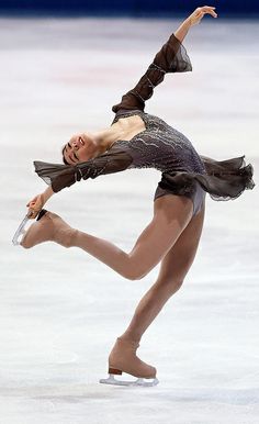 a female figure skating on an ice rink